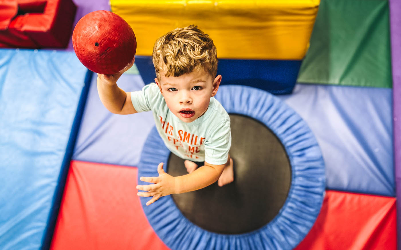A toddler jumping on a Romp n' Roll tramp, learn more about our kids activities in Westbury, .