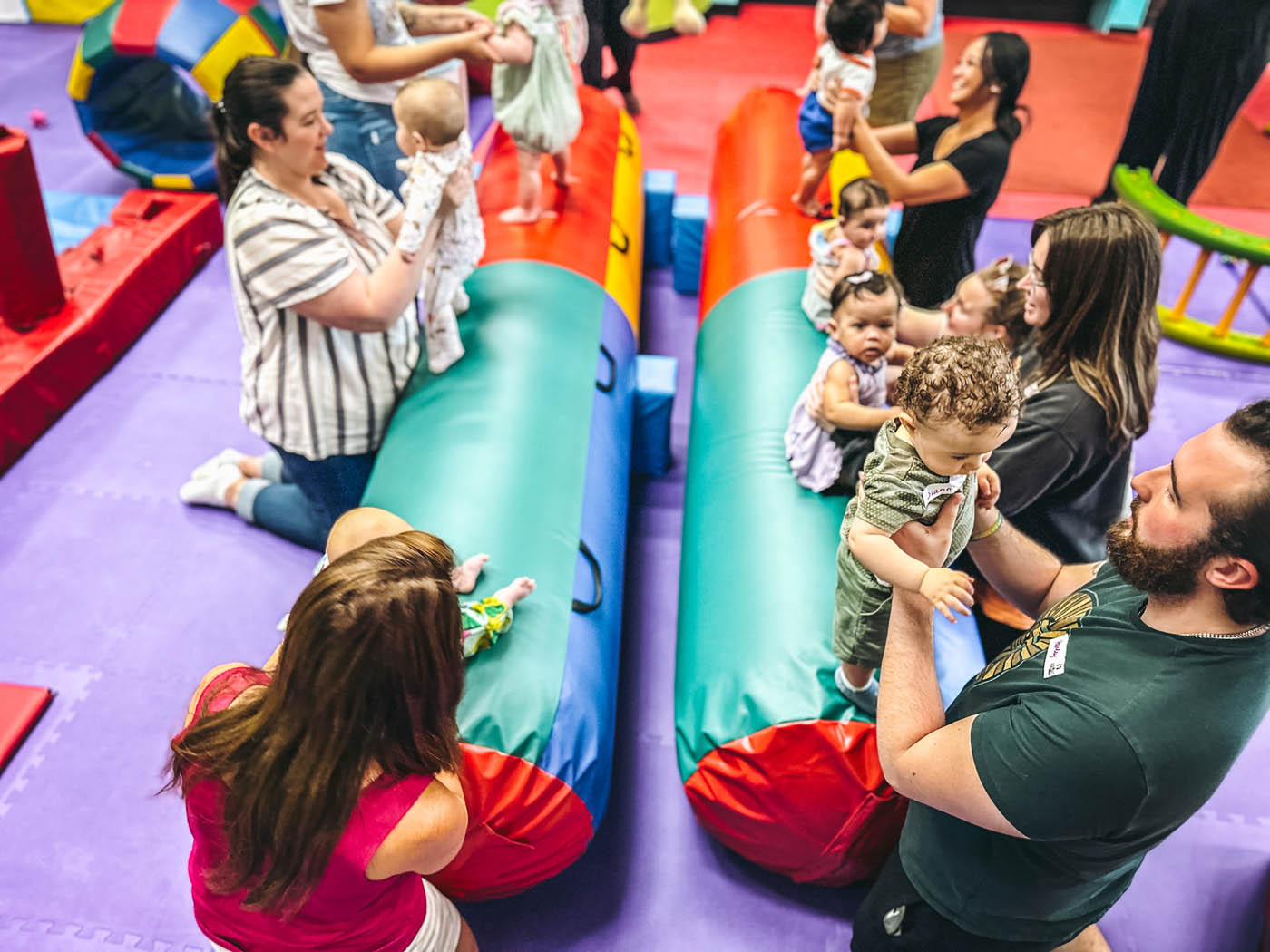 A group of parent and children enjoying Romp n' Roll Willow Grove's gym, review our frequently asked questions at Romp n' Roll Willow Grove.