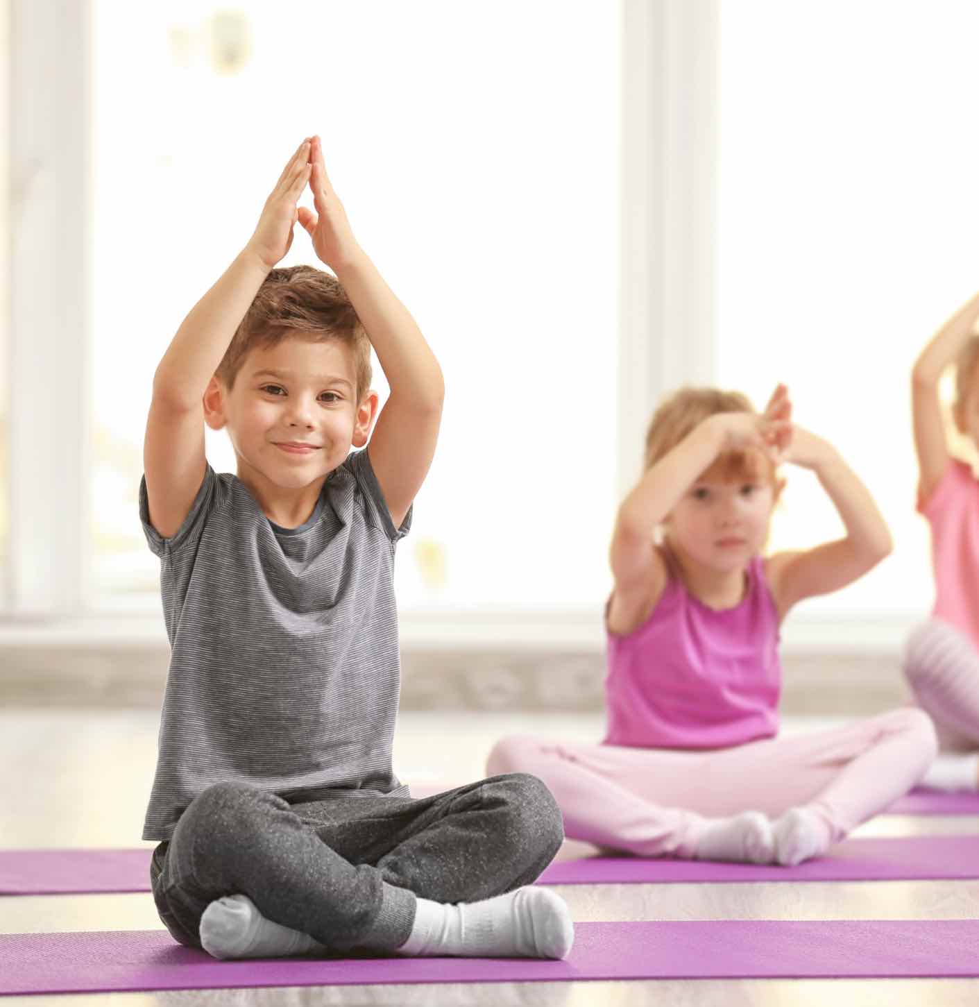 These kids enjoy practicing mindfulness through yoga - learn more tips with Romp n' Roll in Willow Grove, PA!
