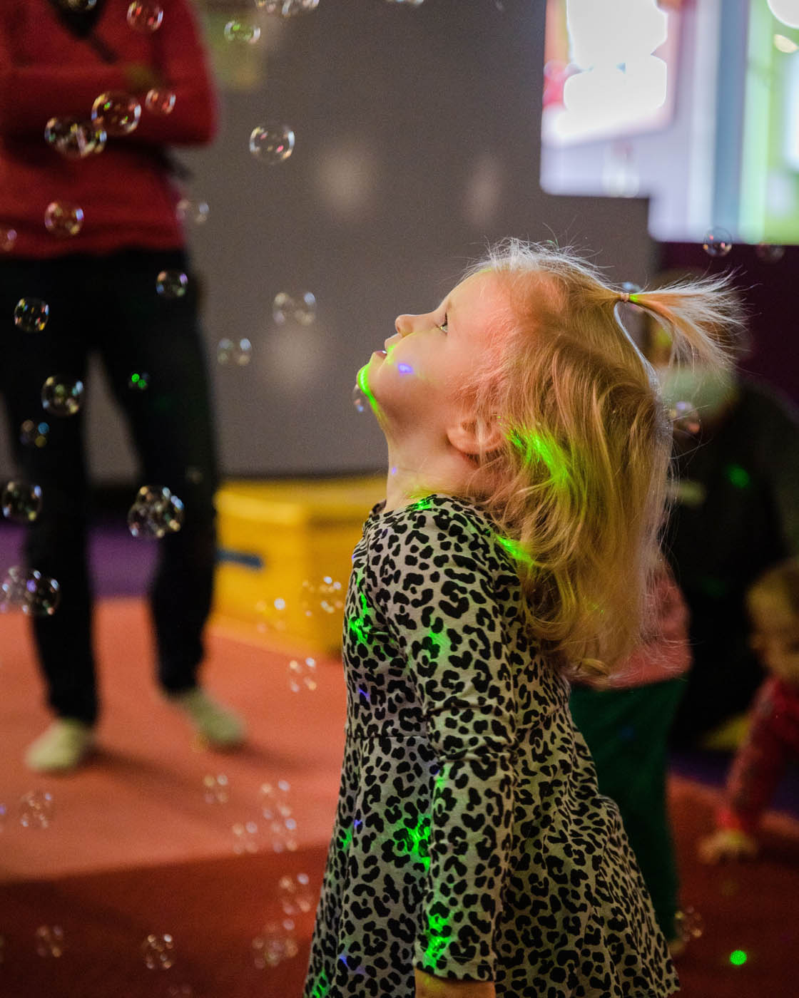 A little girl enjoying classes with bubbles at Romp n' Roll in Raleigh. 