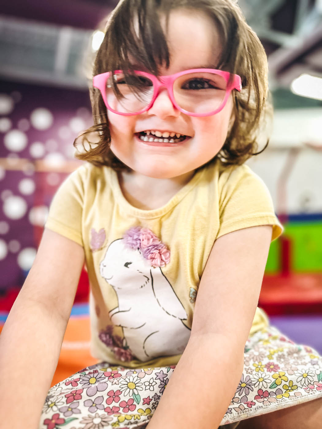 A little girl in cute pink glasses at Romp n' Roll Pittsburgh charitable giving event.