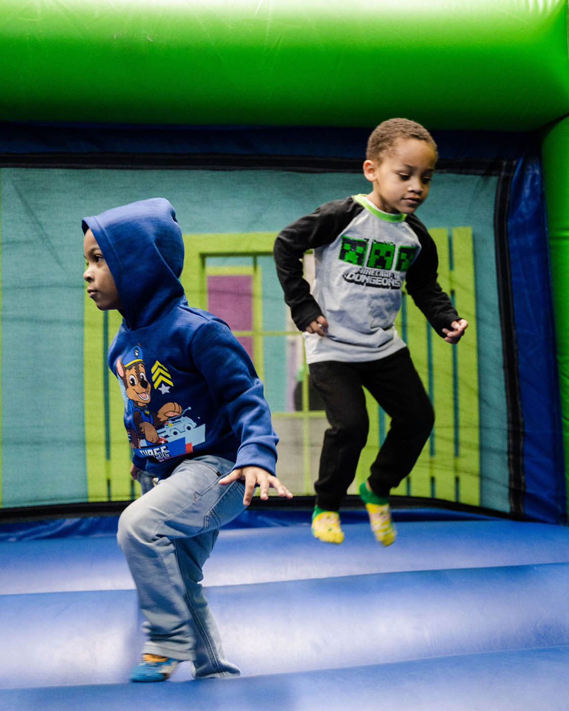 Two boys playing together at a Romp n' Roll gym in Midlothian.