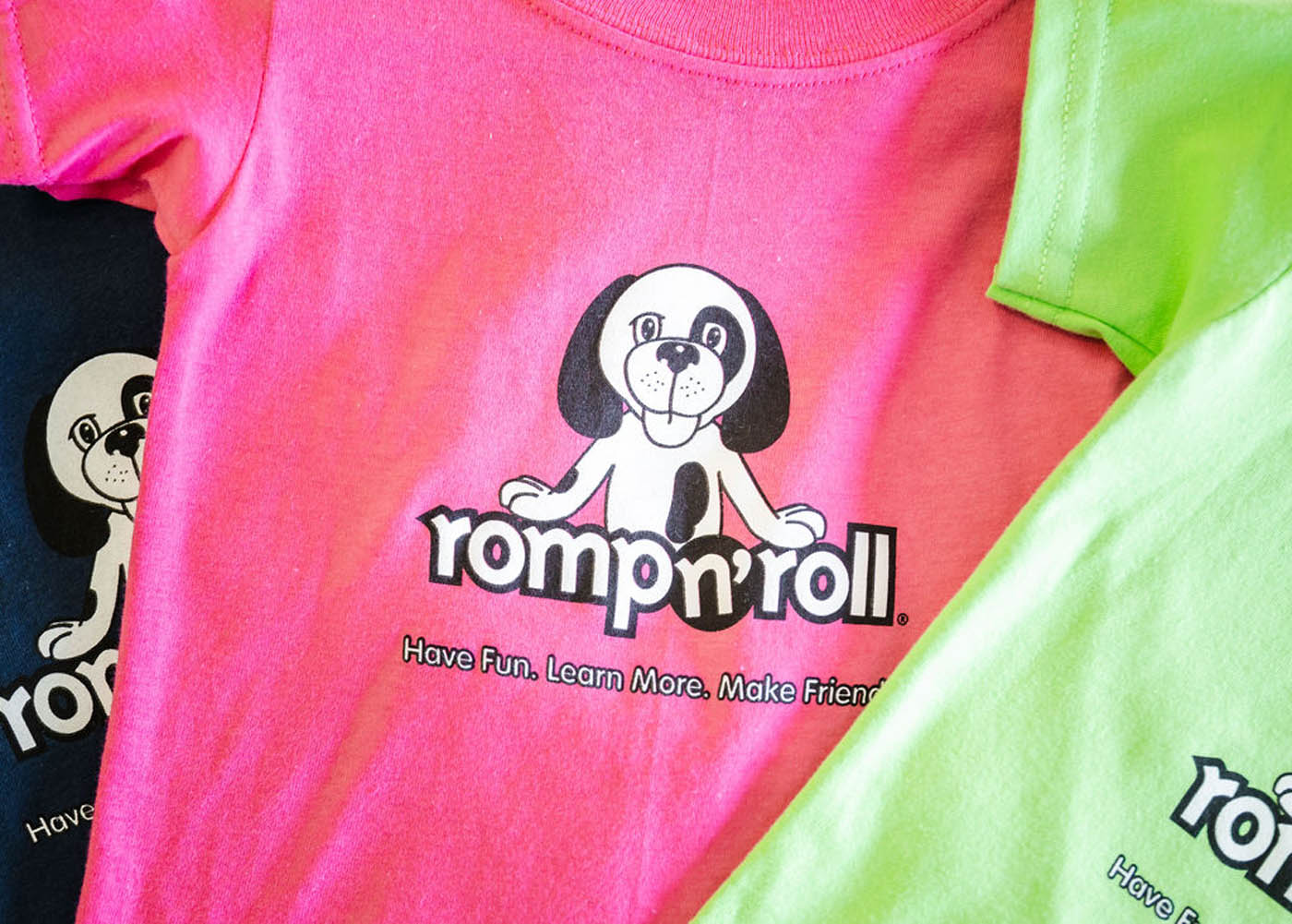 A pink t-shirt with Rompy and the Romp n' Roll logo on the front.