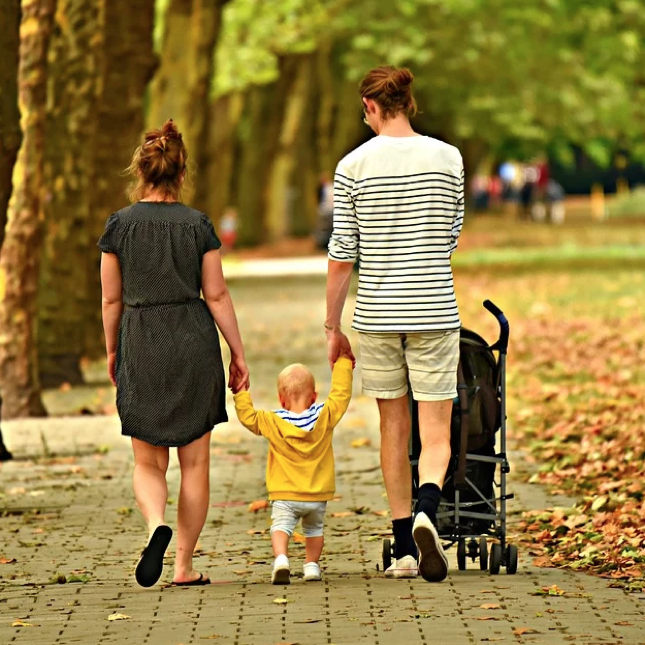 This family is taking a walk in the fall weather - learn more tips to stay active with your kids with Romp n' Roll.
