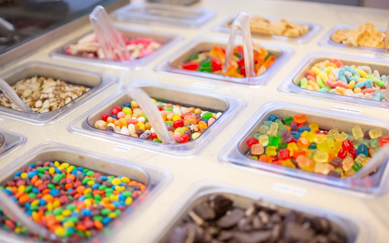 Ice cream toppings displayed at an ice cream shop.