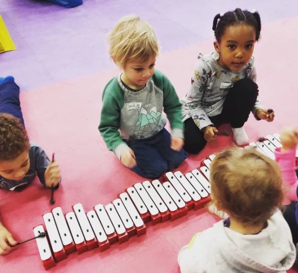 Cute kids learning and enjoying our music classes at Romp n' Roll.