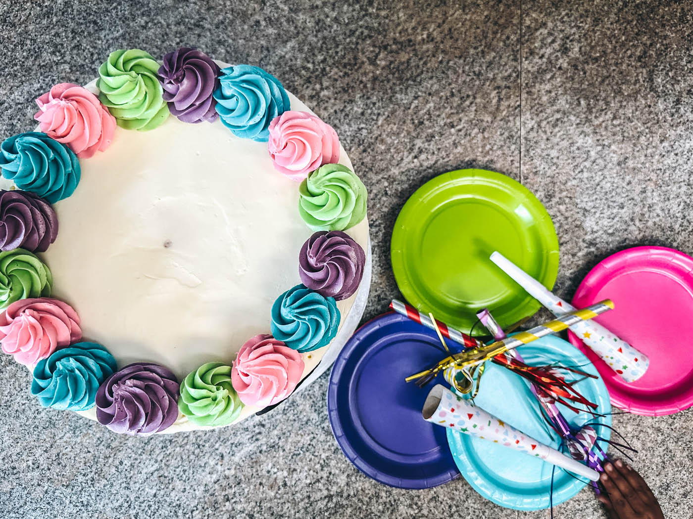 A cake and party supplies - party utensil supplies provided at Romp n' Roll toddler birthday venues in Midlothian, VA.