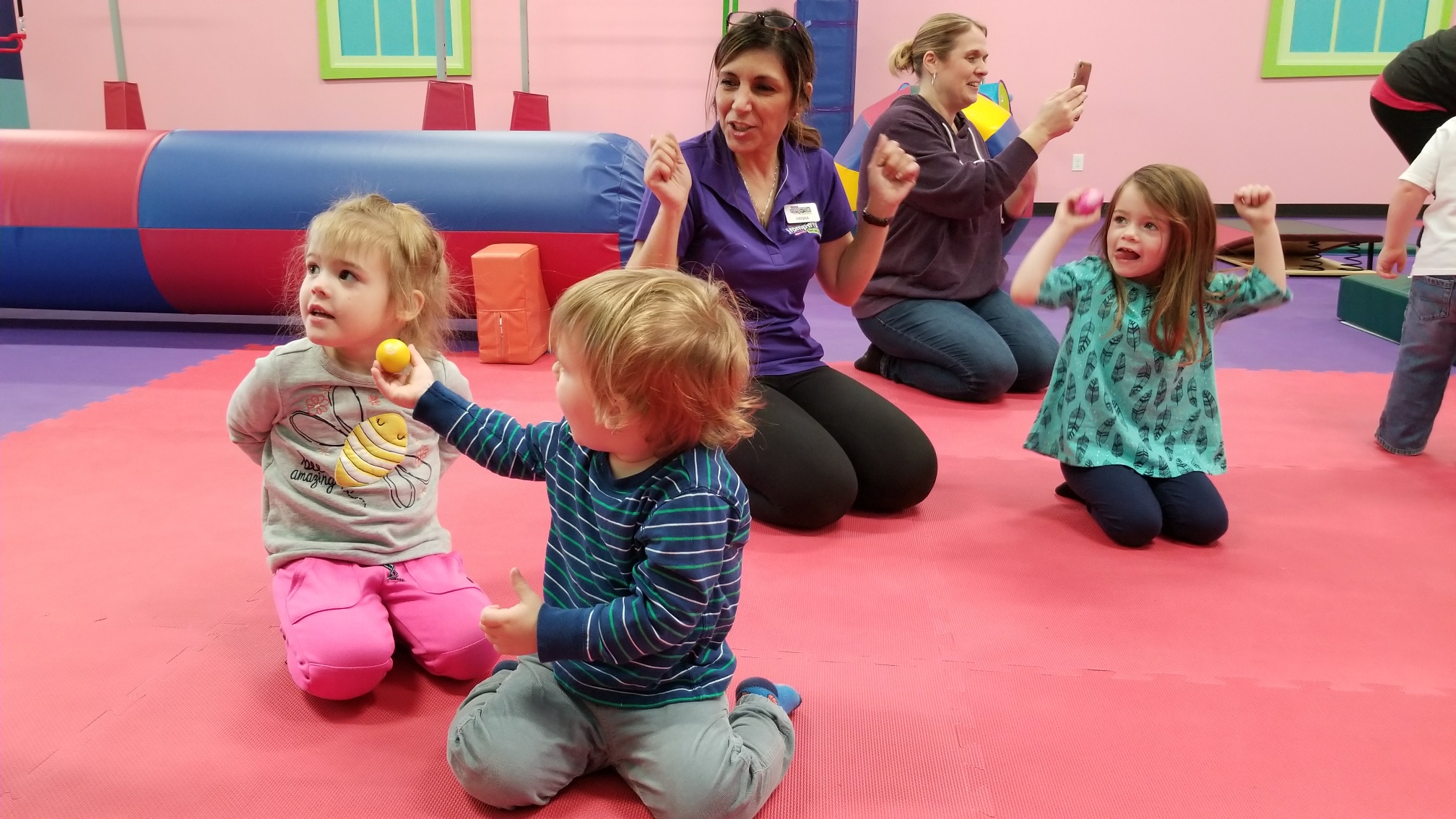 A group of kids in a Romp n' Roll class with adults - baby & toddler classes in Charlotte, NC