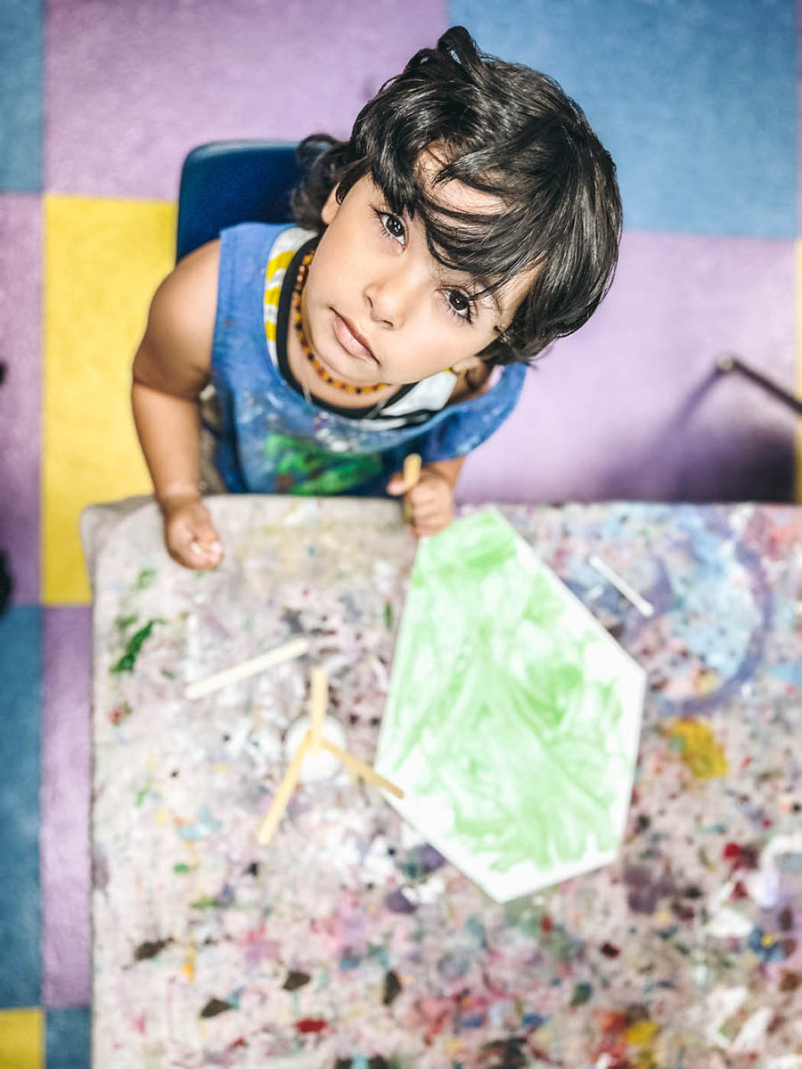 A shot of a boy from up above enjoying Charlotte toddler art classes with Romp n' Roll. 