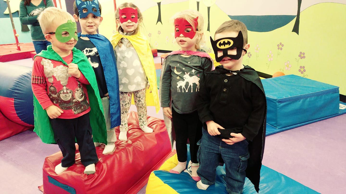 Group of kids having fun in costumes at a Romp n' Roll event.