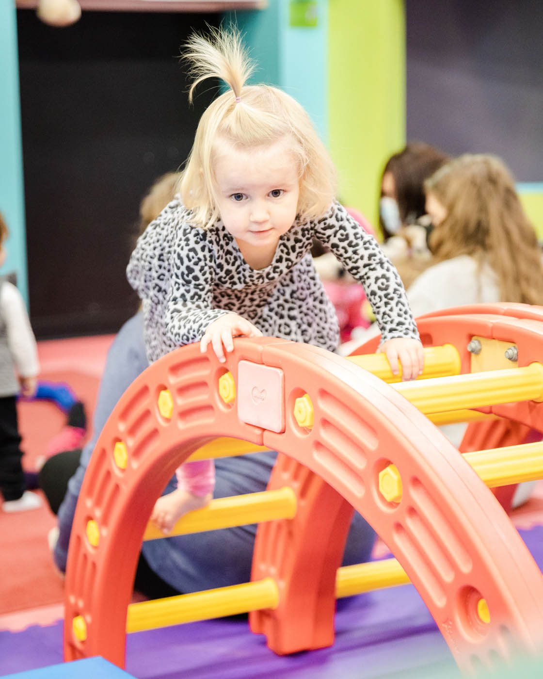 A young girl climbing on our equipment at Romp n' Roll - we are a indoor playground franchise, join us!