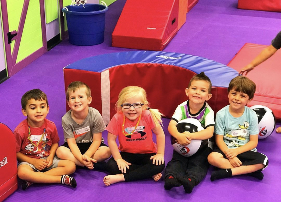 A group of children having fun at a Romp n' Roll class.