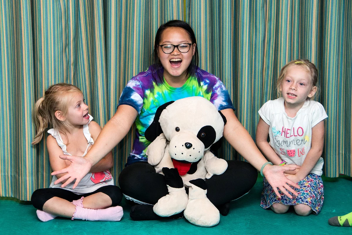 An adult playing with kids at a Rompy birthday party at Romp n' Roll.