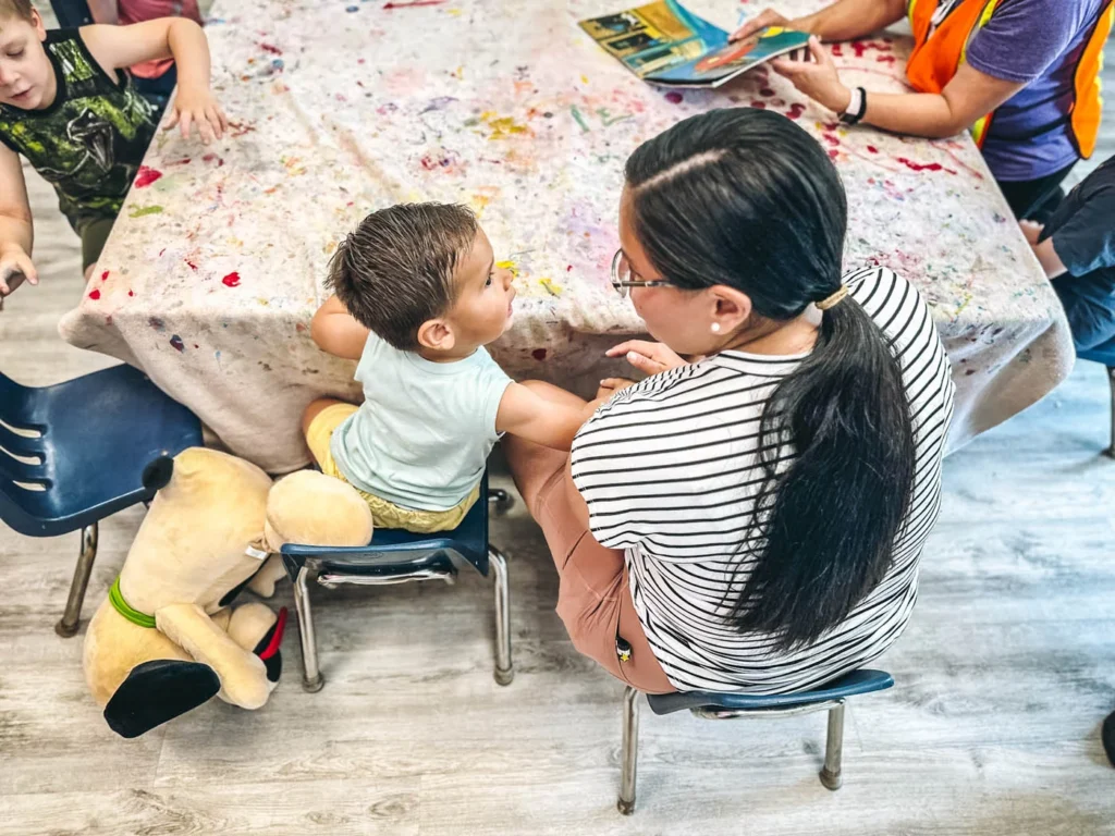 A mom and child participating in an art summer camp for preschoolers.