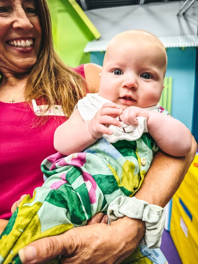 Romp n' Roll instructor with a baby enjoying the benefits of our classes.