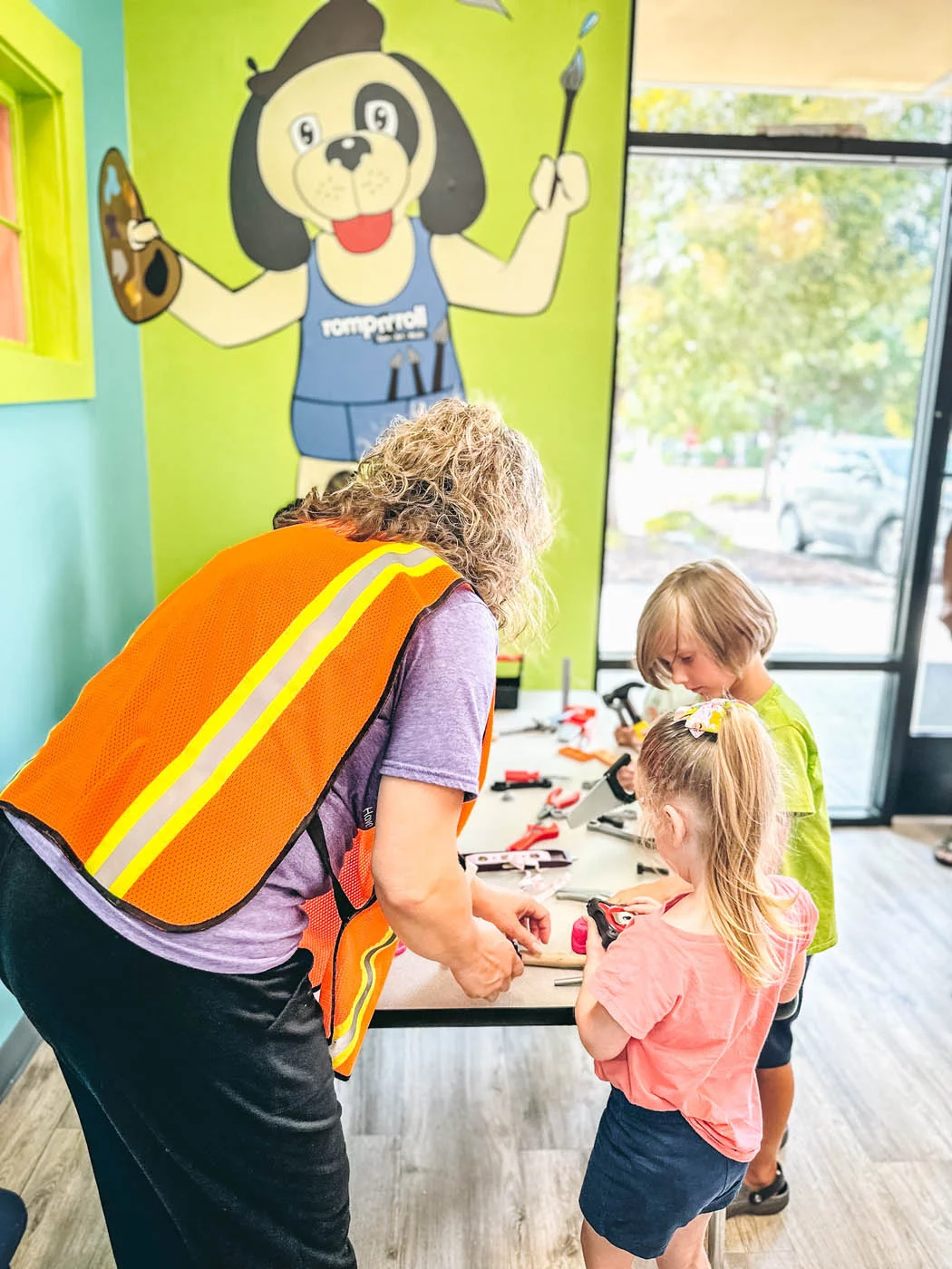 A teacher and child participating in one of Romp n' Roll' childrens events.