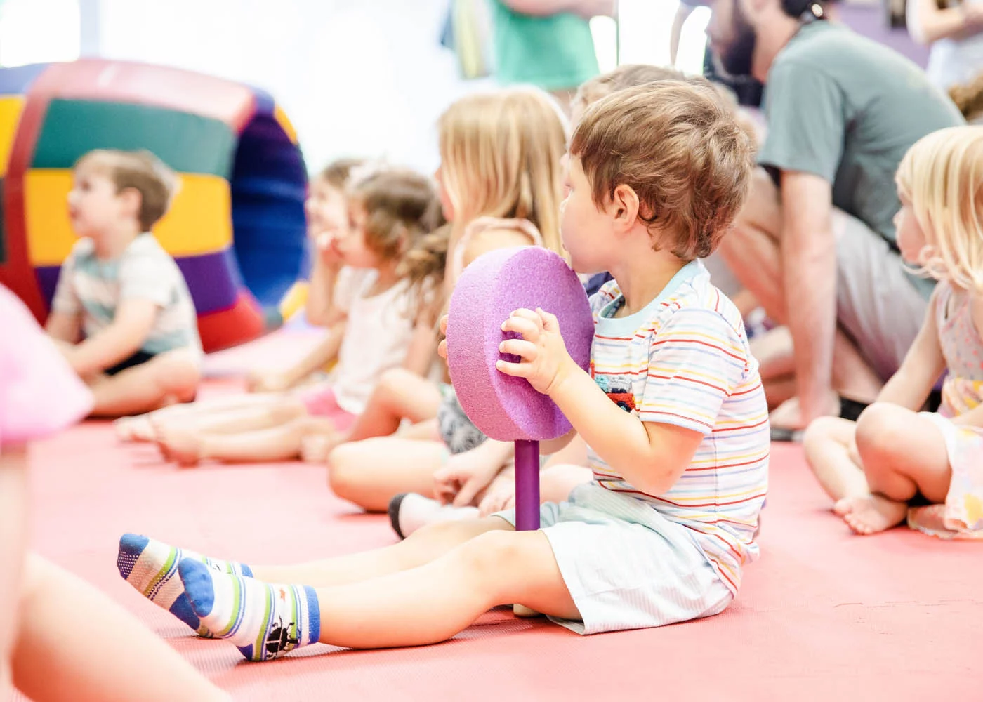 A little girl playing with some ribbon at a kids night out event.